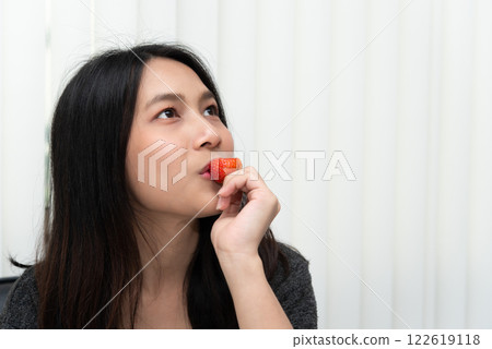 Woman eat strawberry red berry fruit sweet juicy 122619118
