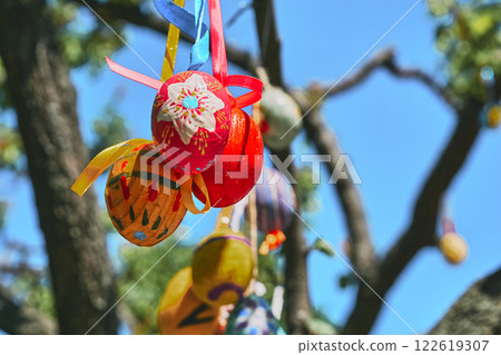 Red yellow Easter eggs on green spring tree Red yellow Easter eggs on green spring tree 122619307