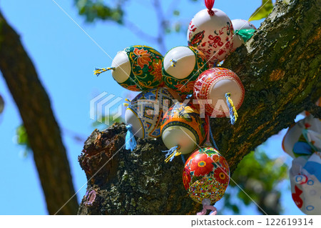 Lot of colorful painted Easter eggs on green spring tree 122619314