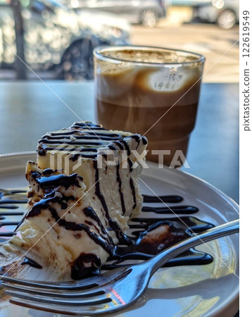 Cheesecake with latte at a cafe table Cheesecake with latte at a cafe table 122619549