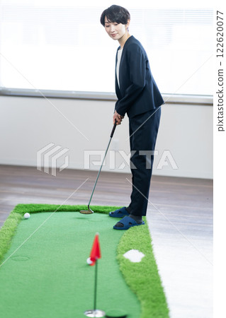 A winning female president practicing golf in the office A winning female president practicing golf in the office 122620077