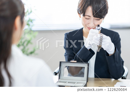 A specialist watch buyer who evaluates watches A specialist watch buyer who evaluates watches 122620084