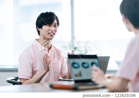 A young male care manager having a meeting 122620106