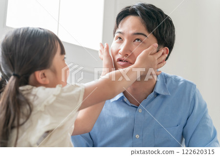 Dad making funny faces with his 9-year-old daughter Dad making funny faces with his 9-year-old daughter 122620315