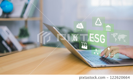 ESG environmental social governance investment business concept, Environmental and business growth together, Human hand using laptop to analyze ESG on screen in business investment strategy concept. 122620664