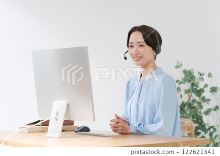 Middle-aged woman having an online meeting while teleworking 122621341