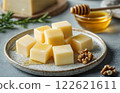 cheese cubes on plate, restaurant serving with honey, nuts and greenery 122621611