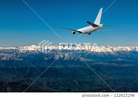 A white wide body jetliner approach in a resort mountain town 122622296
