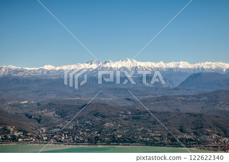 View of the town by the sea and high mountains covered with snow View of the town by the sea and high mountains covered with snow 122622340