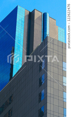 Modern Architectural Symmetry. A sleek composition of geometric lines and reflective glass, embodying contemporary urban design. Ideal for branding, portfolios, or urban concepts Modern Architectural Symmetry. A sleek composition of geometric lines and reflective glass, embodying contemporary urban design. Ideal for branding, portfolios, or urban concepts 122622476
