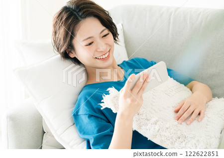 A young woman looking at a sleep with lying down A young woman looking at a sleep with lying down 122622851