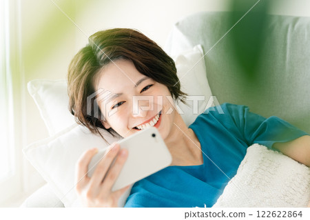 A young woman looking at a sleep with lying down A young woman looking at a sleep with lying down 122622864