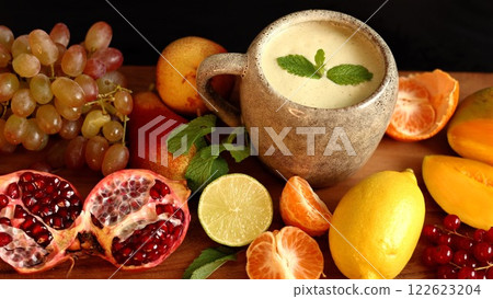 Bright mix of mango, lime, and tangerine emphasizes organic health benefits. Eco-conscious ingredients create fresh organic vibe, highlighting eco harmony with vibrant colors. 122623204