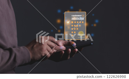 Young Man hand holding Smart Phone with five star to review and give 5 stars  122626998