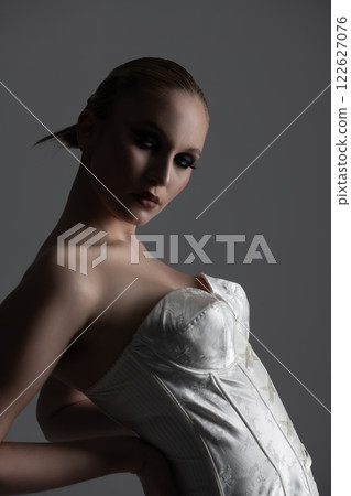 Beautiful woman dark silhouette studio portrait on gray background 122627076