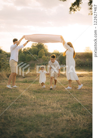 Happy family having fun in nature. Family day holiday concept 122627467