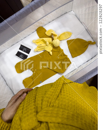 Cozy Baby Crib with Yellow Outfit and Accessories Cozy Baby Crib with Yellow Outfit and Accessories 122628297