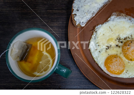Breakfast with Sunny-Side-Up Eggs and Lemon Tea Breakfast with Sunny-Side-Up Eggs and Lemon Tea 122628322