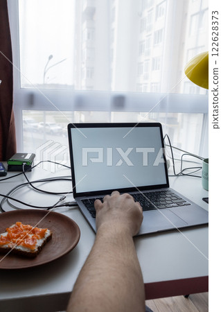 Minimalist Workspace with Laptop and Breakfast 122628373