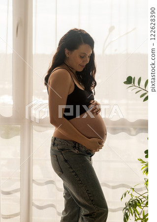 Pregnant Woman by Window in Natural Light Pregnant Woman by Window in Natural Light 122628390