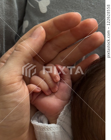 Tender Moment: Adult and Baby Hands 122628558