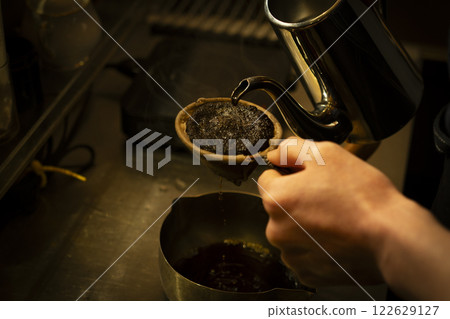 Image of hands brewing coffee with cloth drip 2 Image of hands brewing coffee with cloth drip 2 122629127