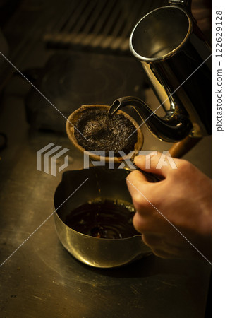 Image of hands brewing coffee with cloth drip 1 122629128