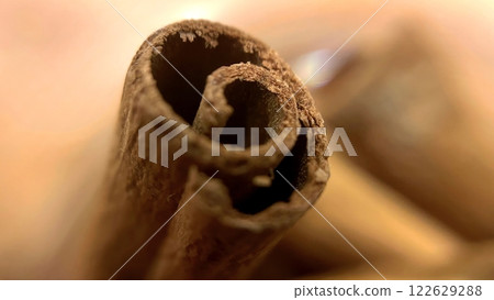 Close-up macro shot of cinnamon sticks showing rich texture and warm brown color. 122629288