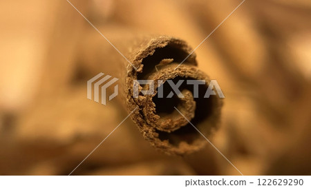 Close-up macro shot of cinnamon sticks showing rich texture and warm brown color. Close-up macro shot of cinnamon sticks showing rich texture and warm brown color. 122629290