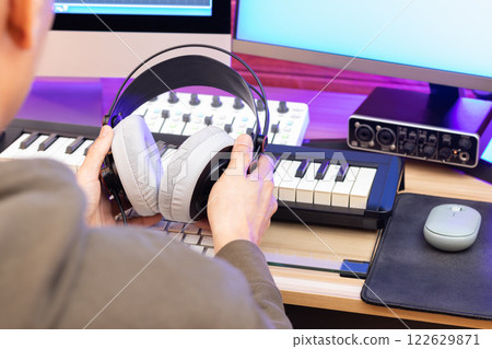 studio headphone in male professional music producer hands. music production concept 122629871