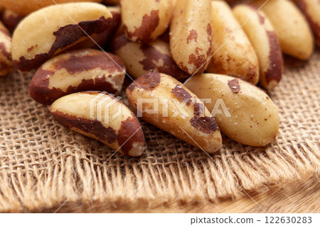 Raw Brazil nuts on coarse burlap. Macro. Rustic style view. Raw Brazil nuts on coarse burlap. Macro. Rustic style view. 122630283