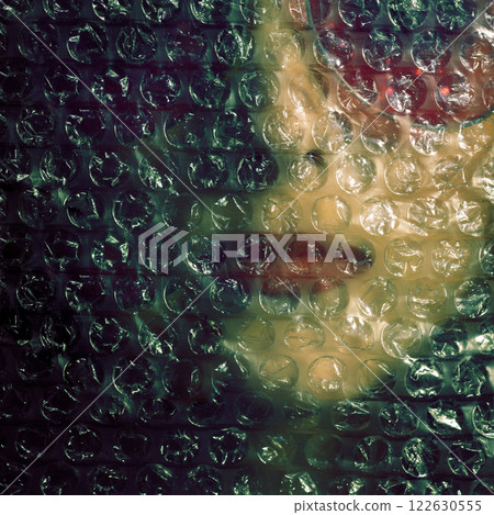 Abstract woman portrait through plastic bubble wrap 122630555