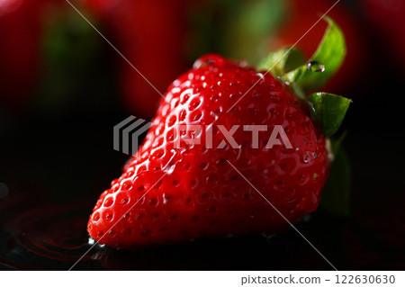 Water drops falling on strawberries Water drops falling on strawberries 122630630