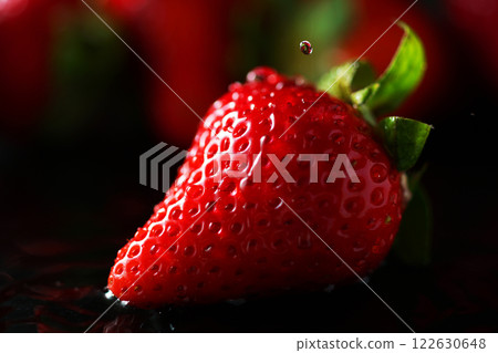 Water drops falling on strawberries 122630648