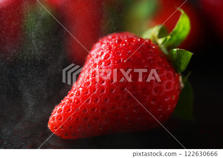 Fresh strawberries receiving water drops Fresh strawberries receiving water drops 122630666