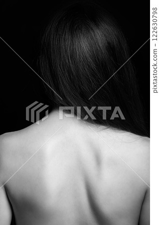 Beautiful naked woman back in black background 122630798