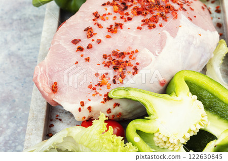 A photo of raw pork on the table. 122630845
