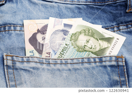 Italian Lira in the pocket of blue jeans Italian Lira in the pocket of blue jeans 122630941