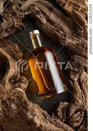 Bottle of whiskey and old dried snags. 122631329