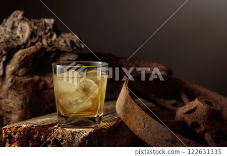 Whiskey with ice on a old wooden board. Whiskey with ice on a old wooden board. 122631335
