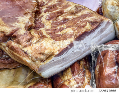 Deliciously smoked pork belly displayed at a local market stall in autumn with vibrant colors and rich textures Deliciously smoked pork belly displayed at a local market stall in autumn with vibrant colors and rich textures 122631666