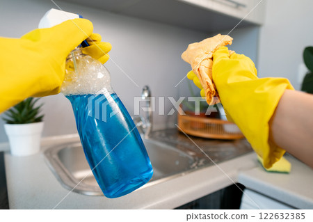 Moment of cleanliness: woman doing a deep clean, removing dust and dirt from every corner of her home. Moment of cleanliness: woman doing a deep clean, removing dust and dirt from every corner of her home. 122632385