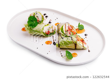 Fresh vegetable rolls displayed elegantly on a white plate with vibrant garnishes and drizzles Fresh vegetable rolls displayed elegantly on a white plate with vibrant garnishes and drizzles 122632544