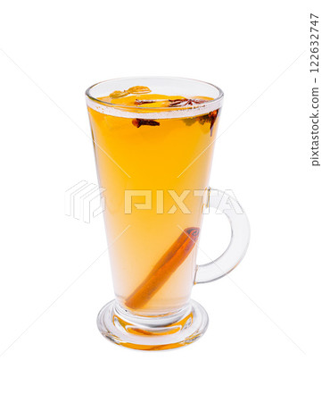 Warm spiced drink with cinnamon and cloves served in a clear glass cup on a white background at a cozy cafe Warm spiced drink with cinnamon and cloves served in a clear glass cup on a white background at a cozy cafe 122632747