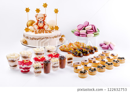 Celebration dessert table featuring a teddy bear cake and assorted sweet treats for a special occasion 122632753