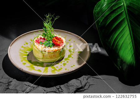 Delicate culinary creation with vibrant greens and fresh ingredients served elegantly on a textured plate 122632755