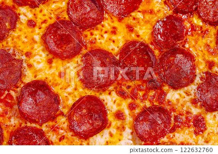 Delicious pepperoni pizza fresh from the oven with melted cheese and crispy crust perfect for a family gathering 122632760