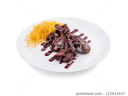 Juicy grilled steak with crispy potato strands and rich sauce on a white plate Juicy grilled steak with crispy potato strands and rich sauce on a white plate 122632817