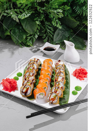Delicious sushi rolls arranged elegantly with wasabi and ginger in a serene setting Delicious sushi rolls arranged elegantly with wasabi and ginger in a serene setting 122632922