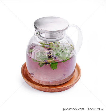 Refreshing herbal infusion served in a glass pitcher with mint and lavender on a wooden tray Refreshing herbal infusion served in a glass pitcher with mint and lavender on a wooden tray 122632937